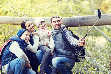 Image showing happy family with smartphone selfie stick in woods