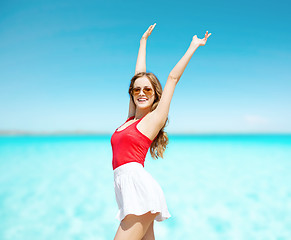 Image showing happy young woman in sunglasses on summer beach