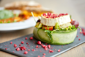Image showing goat cheese salad with vegetables at restaurant