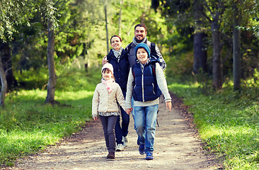 Image showing happy family with backpacks hiking