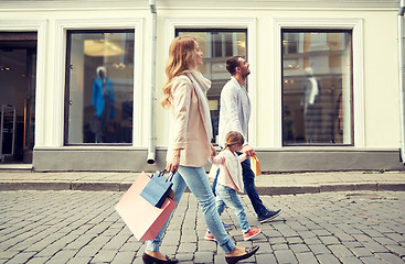 Image showing happy family with child and shopping bags in city