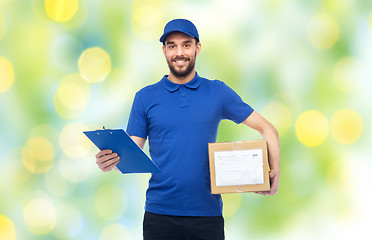 Image showing happy delivery man with parcel box and clipboard