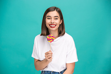 Image showing The young woman with colorful lollipop