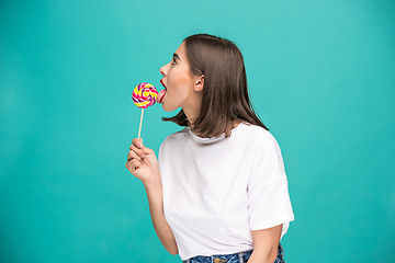 Image showing The young woman with colorful lollipop