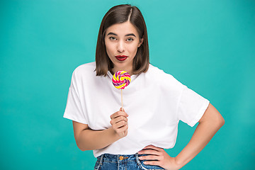 Image showing The young woman with colorful lollipop