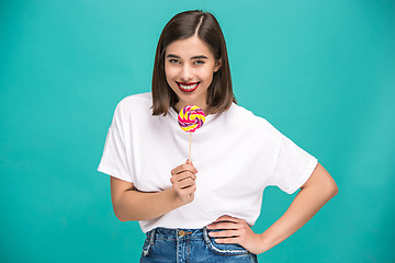 Image showing The young woman with colorful lollipop