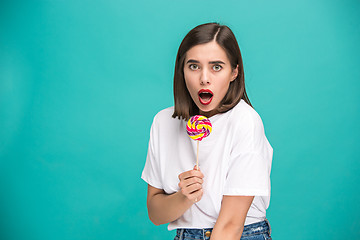 Image showing The young woman with colorful lollipop