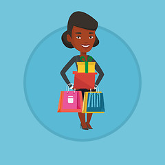 Image showing Happy woman holding shopping bags and gift boxes.