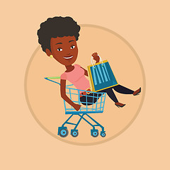 Image showing Happy woman riding by shopping trolley.