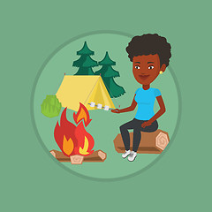 Image showing Woman roasting marshmallow over campfire.