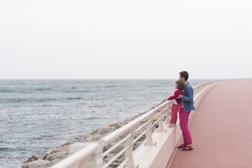 Image showing mother and cute little girl on the promenade by the sea