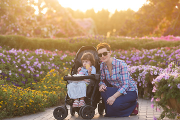 Image showing mother and daughter in flower garden