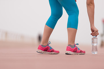 Image showing close up on running shoes and bottle of water