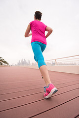 Image showing woman busy running on the promenade