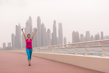 Image showing young woman celebrating a successful training run