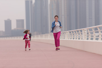 Image showing mother and cute little girl on the promenade