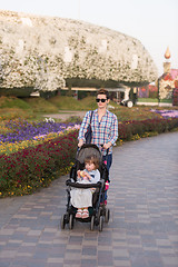 Image showing mother and daughter in flower garden