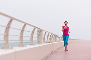 Image showing woman busy running on the promenade