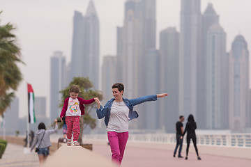 Image showing mother and cute little girl on the promenade