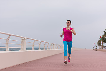 Image showing woman busy running on the promenade