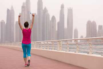 Image showing young woman celebrating a successful training run