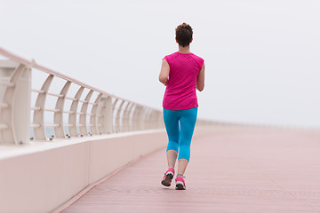 Image showing woman busy running on the promenade