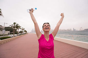 Image showing young woman celebrating a successful training run