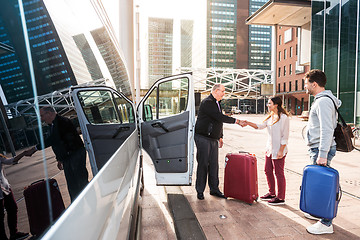 Image showing Airport Shuttle driver and passengers in a big city