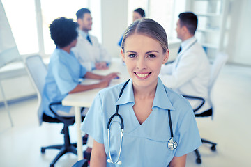 Image showing happy doctor over group of medics at hospital