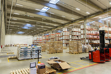 Image showing forklift loader and cargo boxes at warehouse