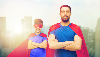 Image showing man and boy wearing mask and red superhero cape