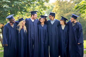 Image showing happy students or bachelors in mortar boards