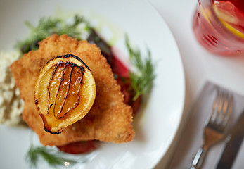 Image showing close up of fish salad with roasted lemon on plate