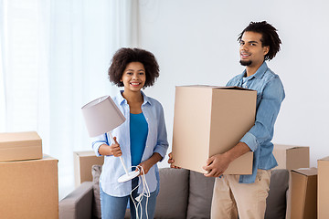 Image showing happy couple with stuff moving to new home