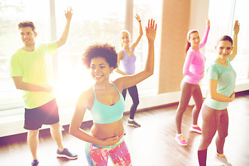 Image showing group of smiling people dancing in gym or studio