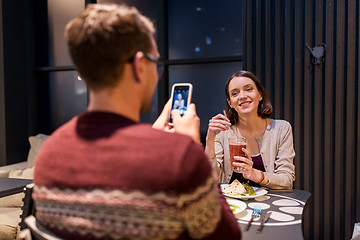 Image showing happy couple having dinner at vegan restaurant
