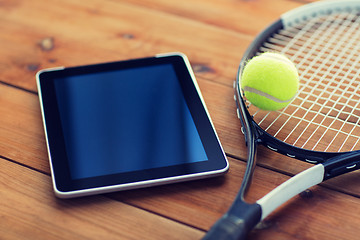 Image showing close up of tennis racket with ball and tablet pc