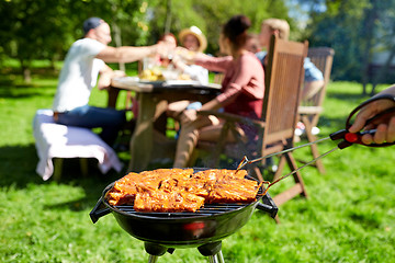 Image showing man cooking meat on barbecue grill at summer party