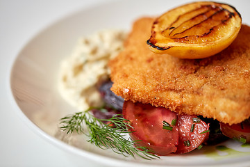 Image showing close up of fish salad with roasted lemon on plate