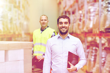 Image showing businessman with clipboard  over warehouse loader