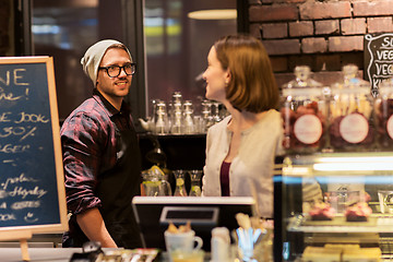 Image showing happy bartenders at cafe or coffee shop counter