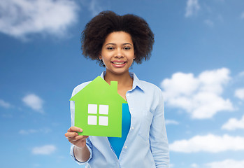 Image showing happy african american woman with green house icon