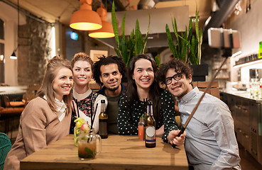 Image showing friends taking selfie by smartphone at bar or cafe