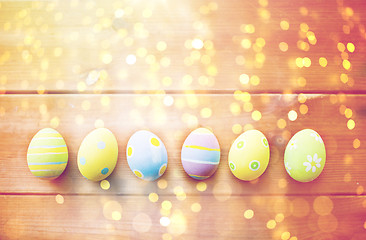 Image showing close up of colored easter eggs on wooden surface