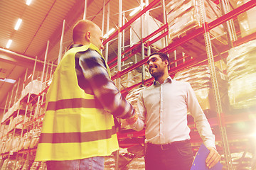 Image showing worker and businessmen with clipboard at warehouse