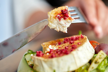 Image showing close up of woman eating goat cheese salad