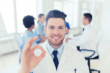 Image showing happy doctor over group of medics at hospital