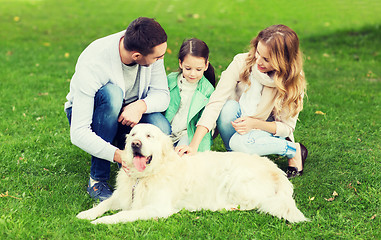 Image showing happy family with labrador retriever dog in park