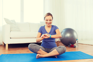 Image showing happy woman with heart-rate watch exercising