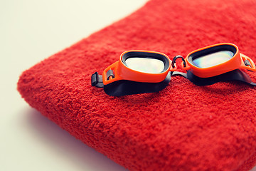 Image showing close up of swimming goggles and towel